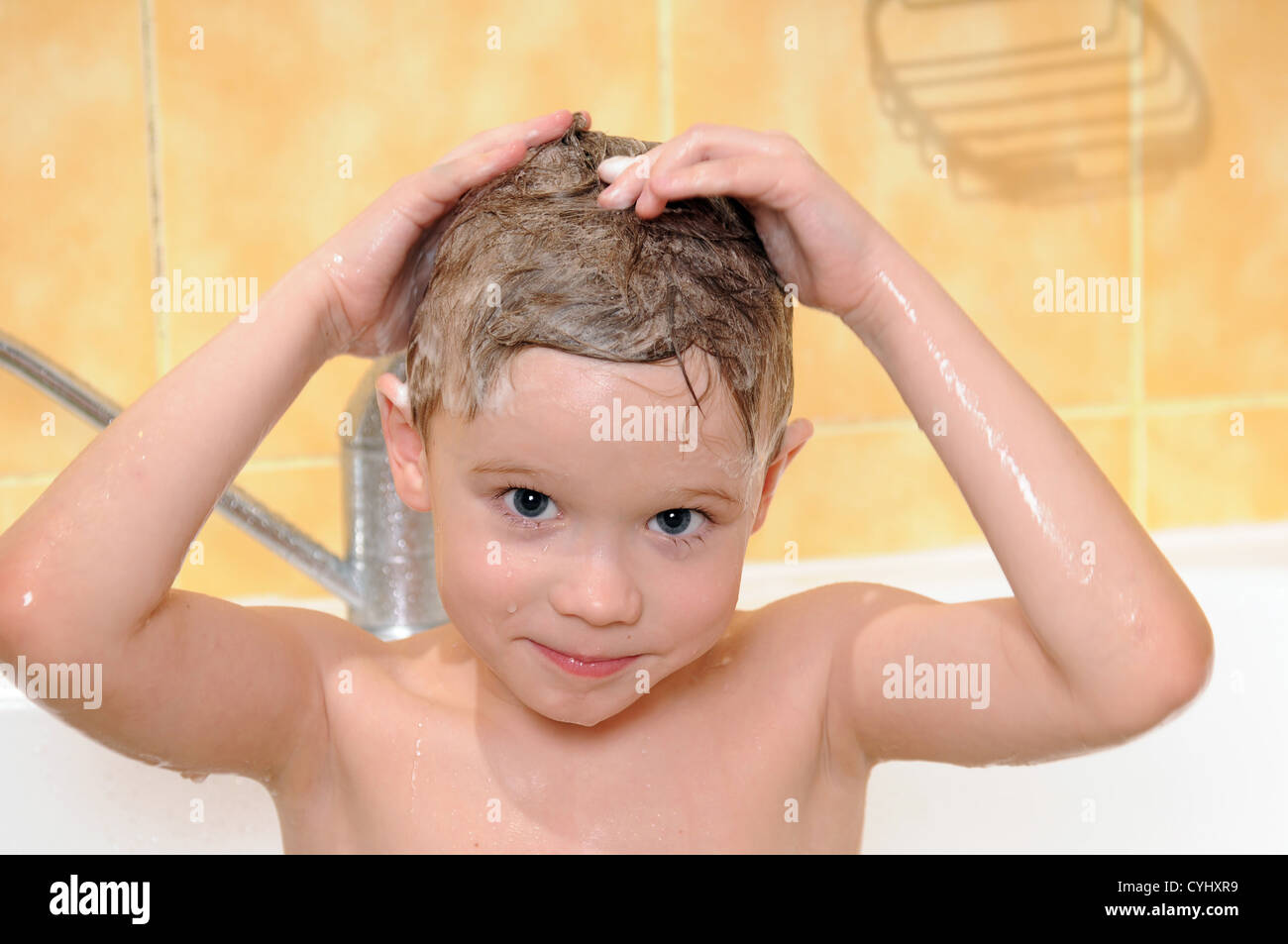 child washing in the shower with a foam on the head Stock Photo Alamy