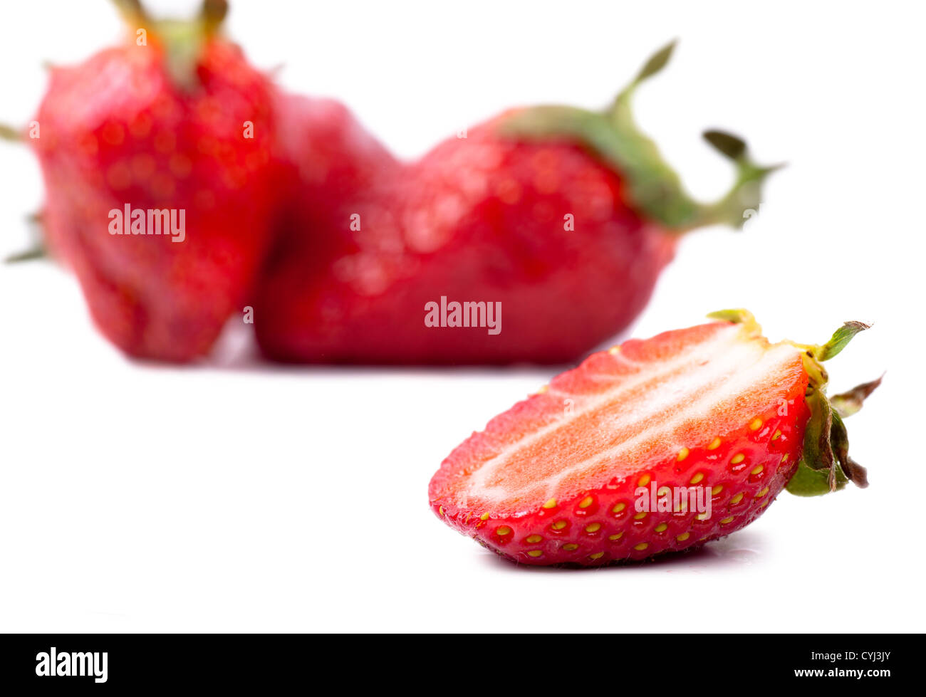 Macro view of fresh strawberries over white background Stock Photo - Alamy