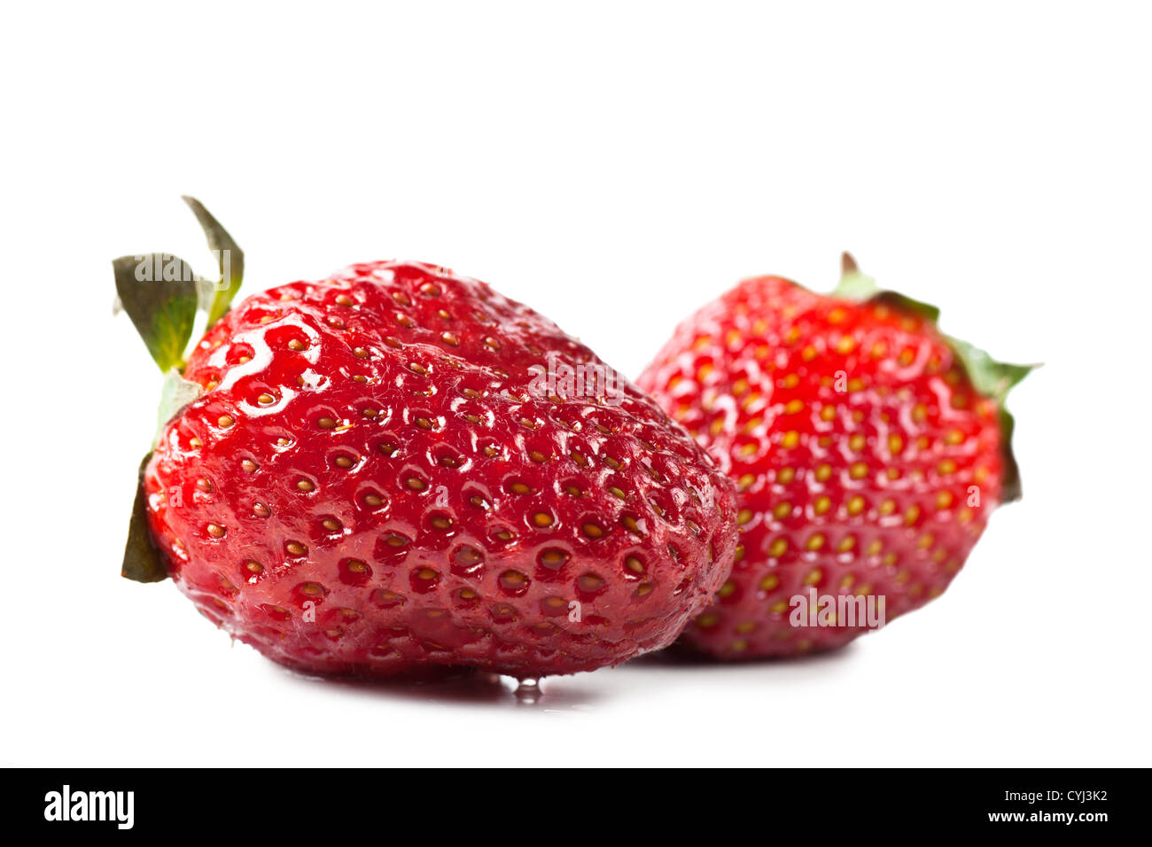 Macro view of two fresh strawberries over white background Stock Photo ...