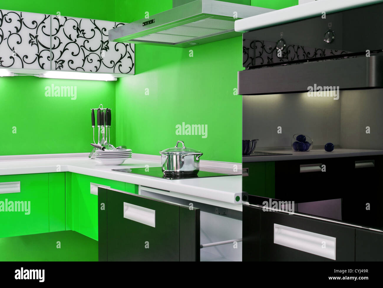 Luxurious new green kitchen with modern appliances Stock Photo