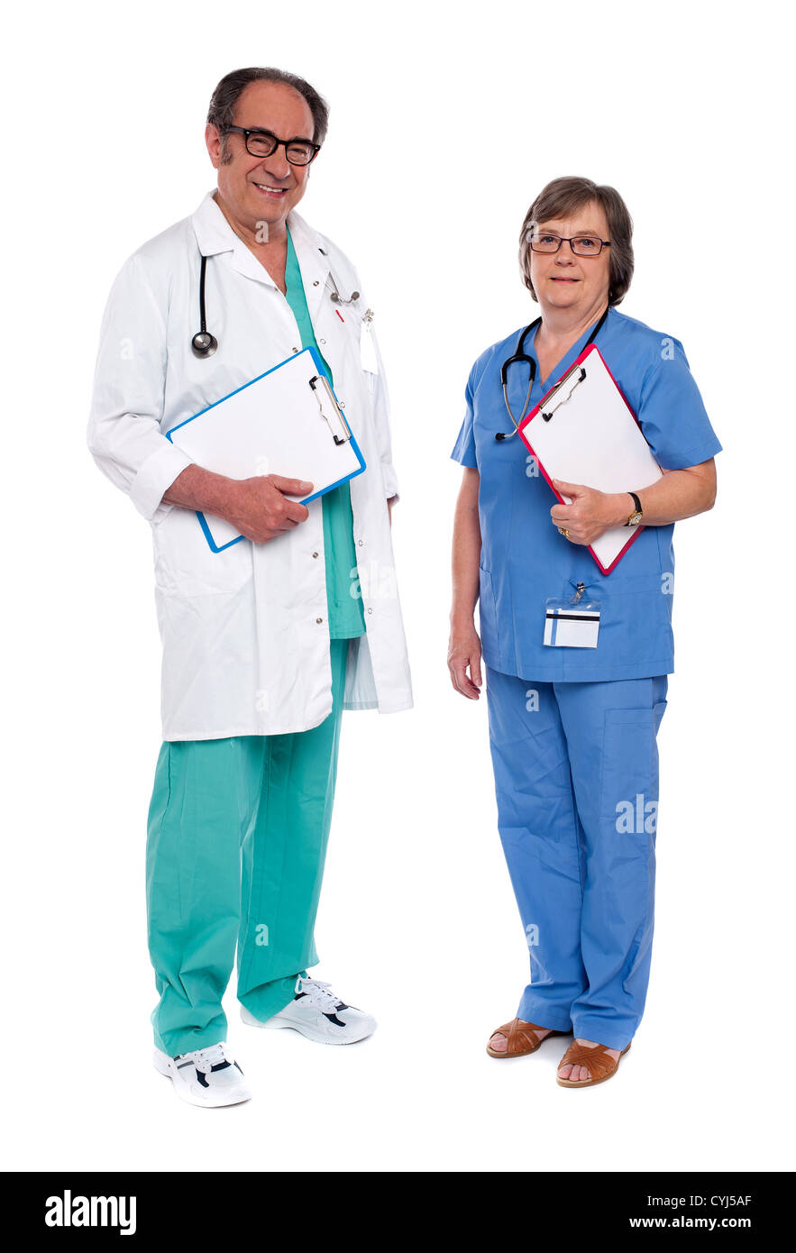 Two medical professionals standing together. Holding reports Stock