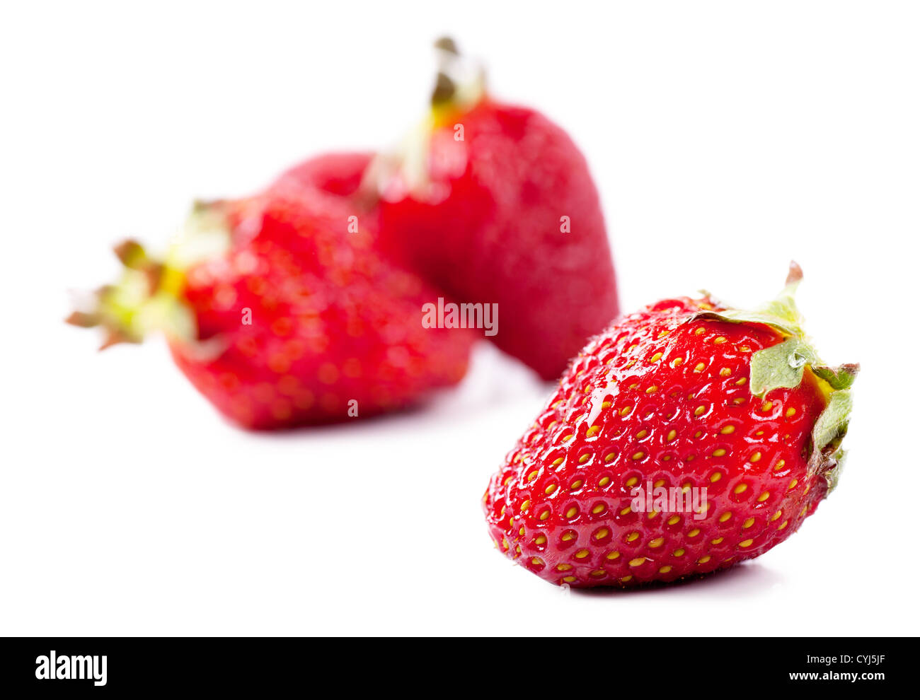 Closeup view of fresh strawberries over white background Stock Photo
