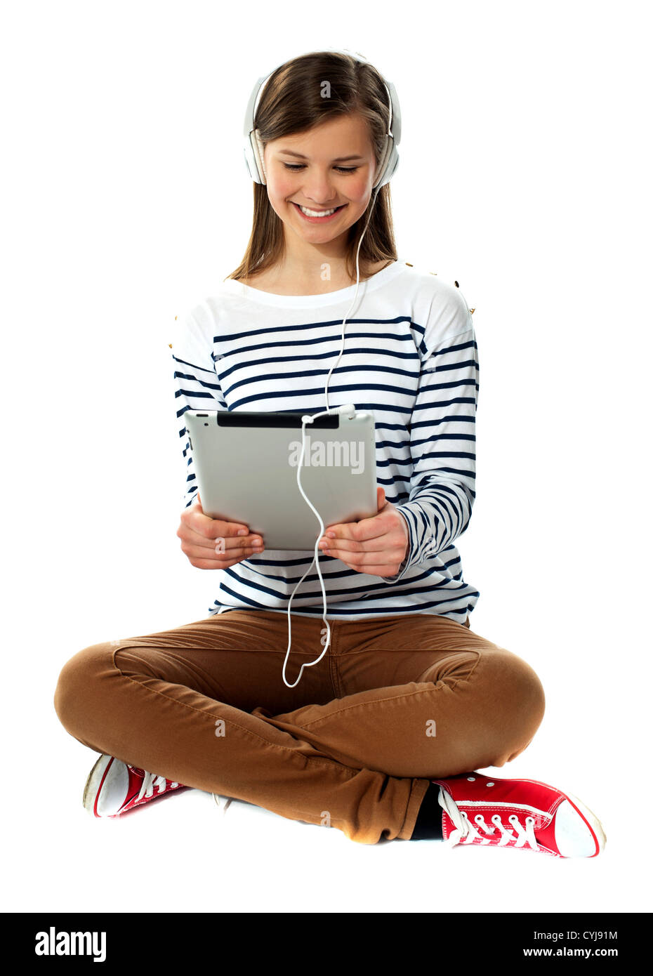 Girl watching video on her tablet with headphones attached Stock Photo Alamy