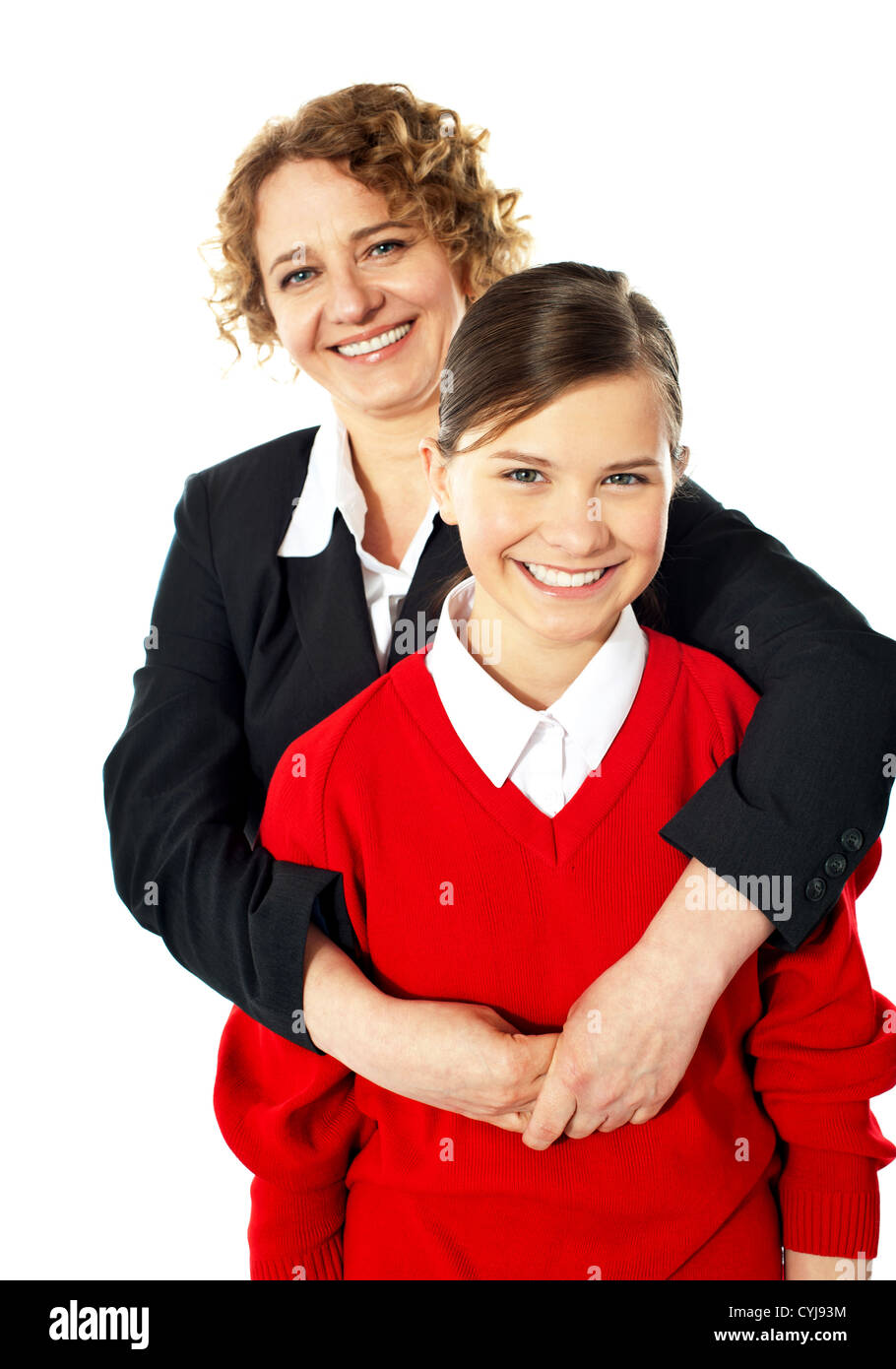 Teacher embracing her student from back and posing in front of camera Stock Photo