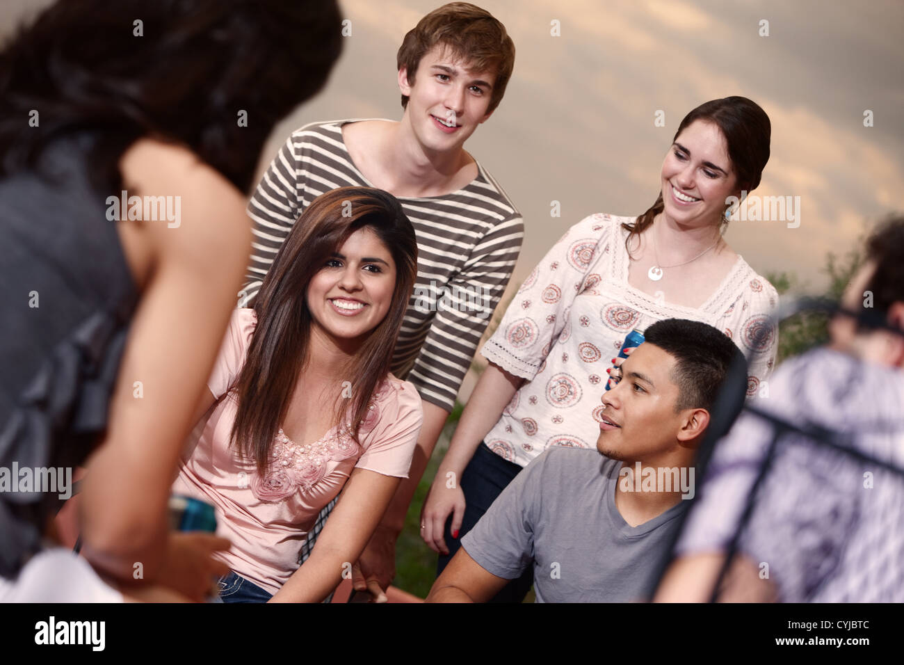 Group of six happy young people outside Stock Photo