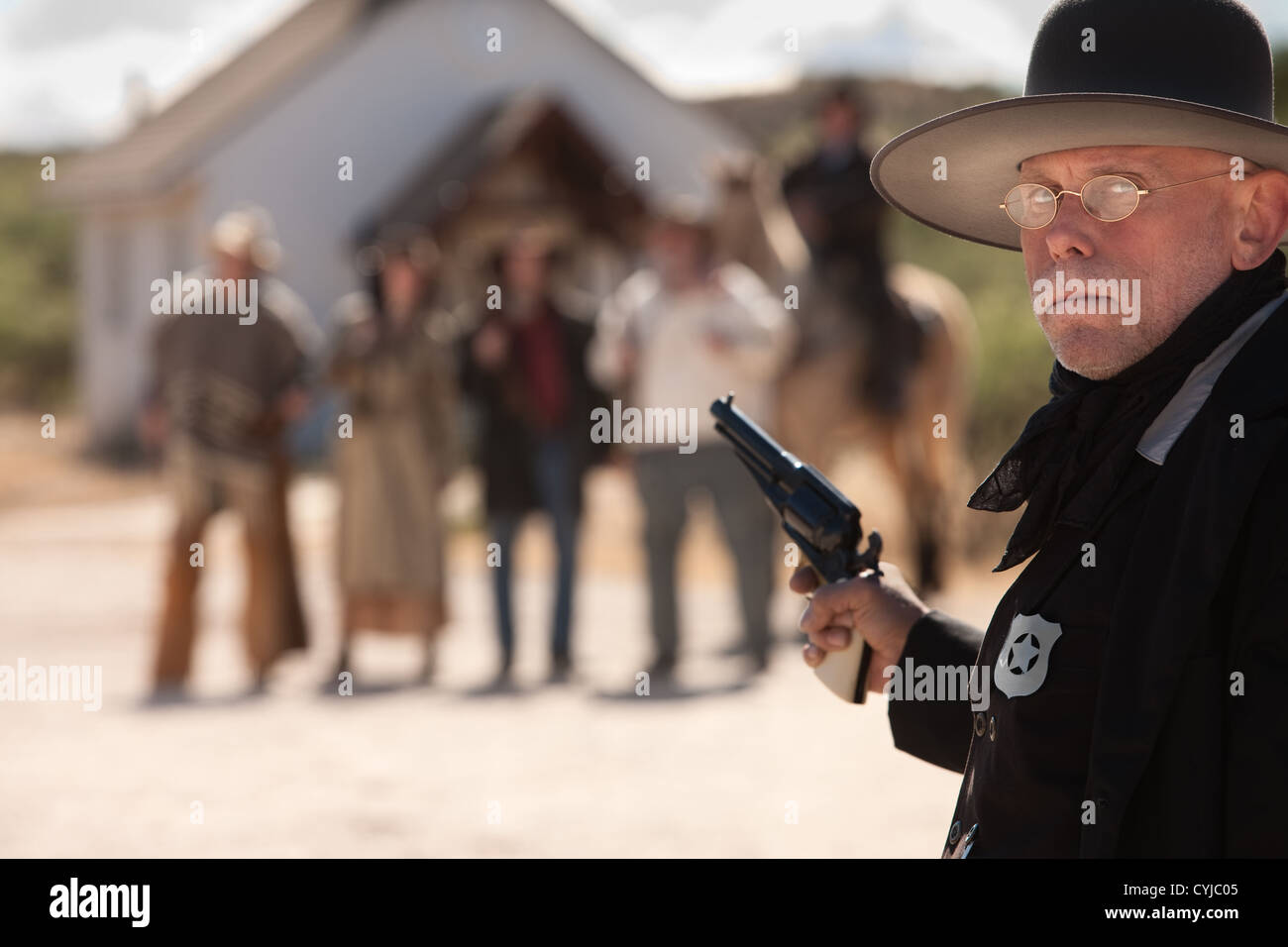 Outgunned sheriff in old American west showdown Stock Photo