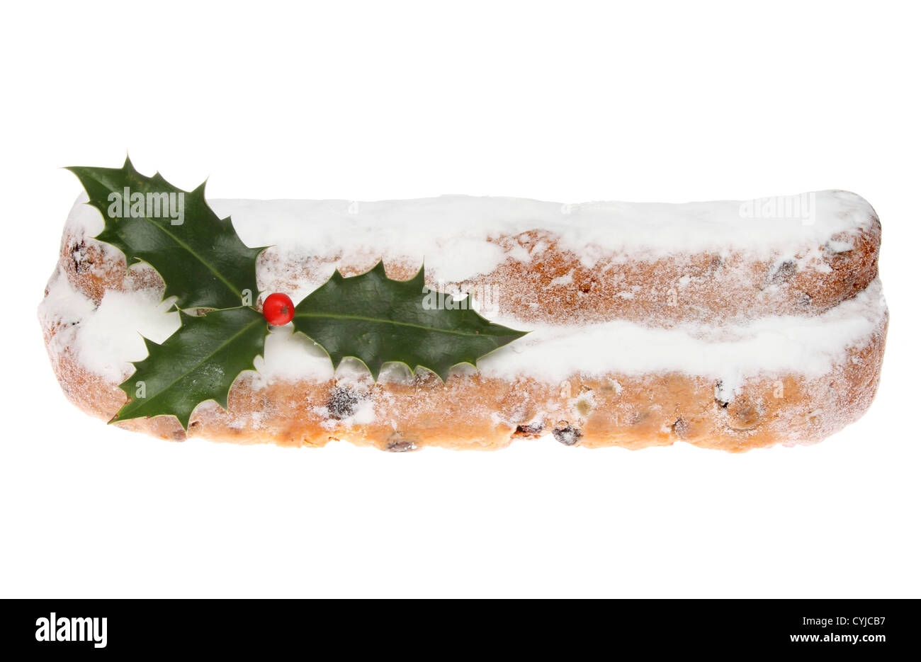 Icing sugar dusted Christmas stollen with a sprig of holly isolated against white Stock Photo