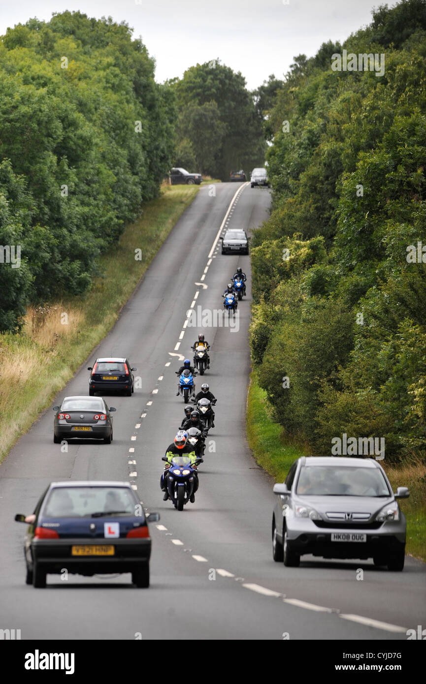 A group of weekend bikers on the Fosse Way road in Gloucestershire UK Stock Photo