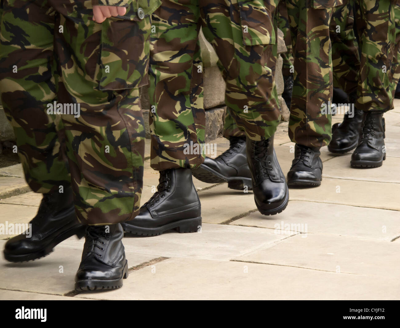 Soldiers black boots marching in line wearing camouflage military ...