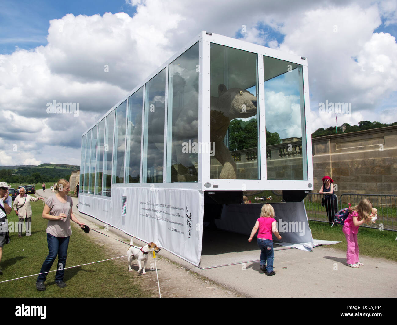 Adults and children playing near large Crochet sculpture in glass case in Chatsworth Derbyshire England Stock Photo