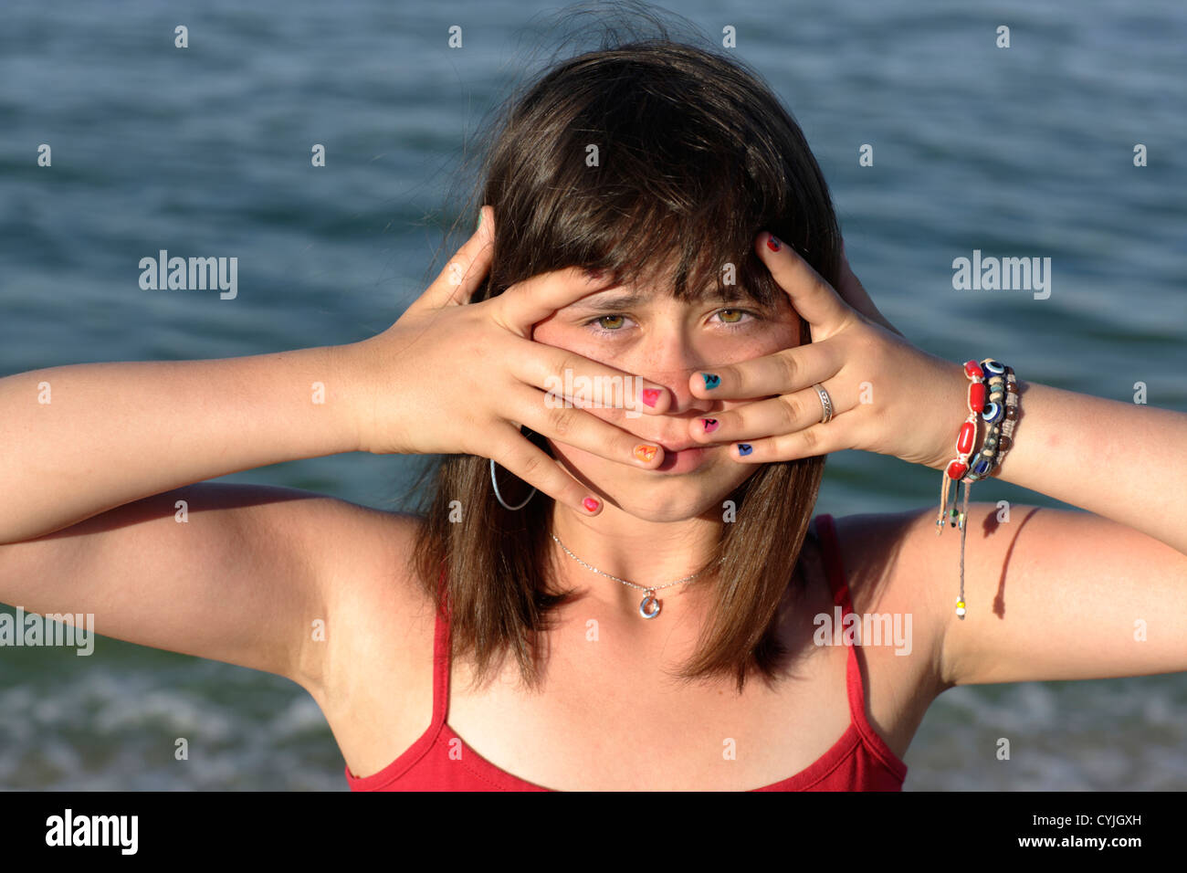 girl shows her painted nails in front of face Stock Photo