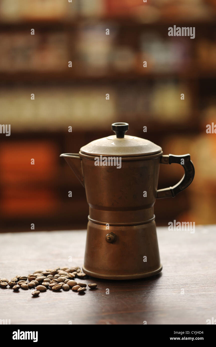 https://c8.alamy.com/comp/CYJHD4/old-coffee-maker-on-wooden-table-CYJHD4.jpg