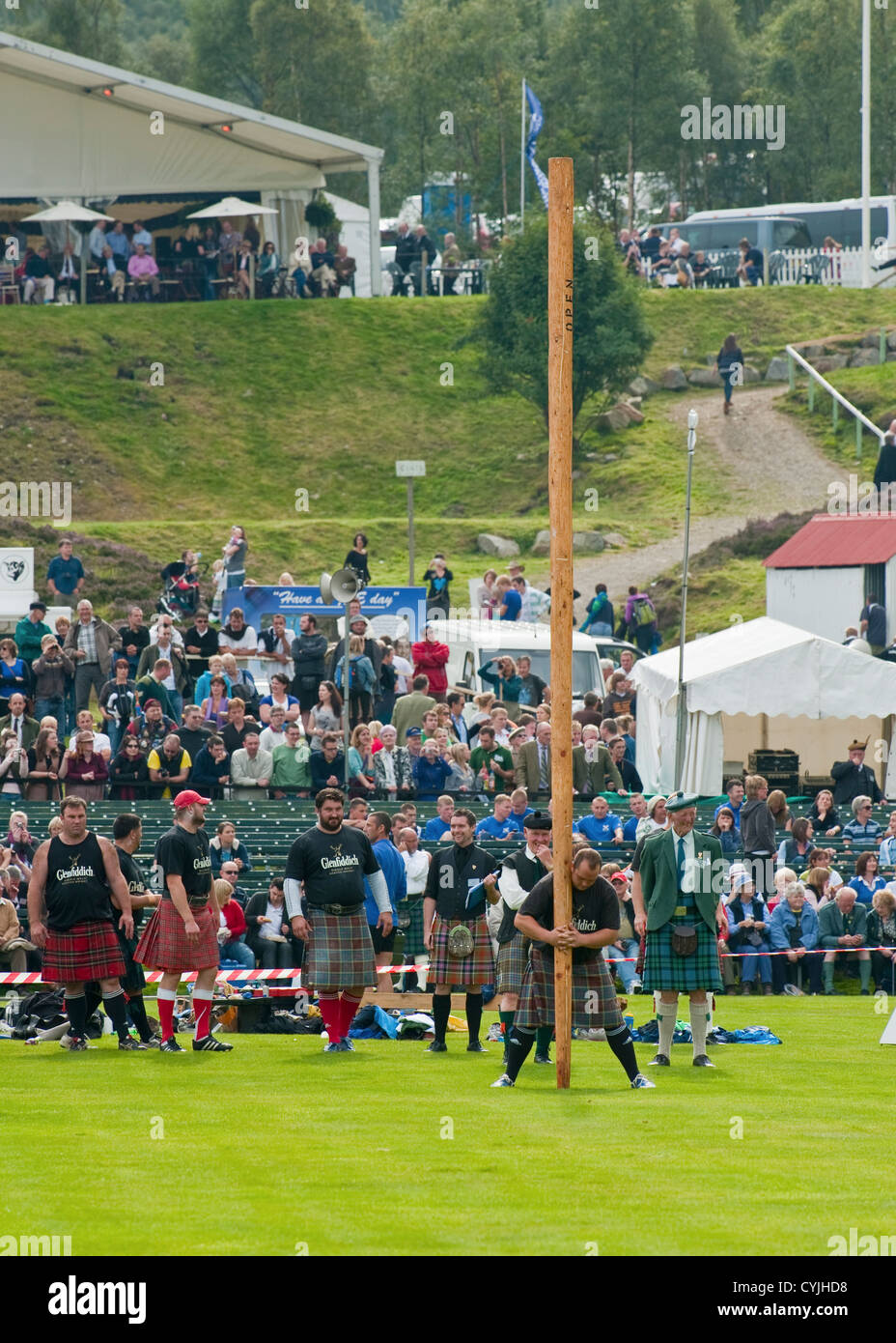 Man competing in a "Toss the Caber" competition at the Royal Highland ...