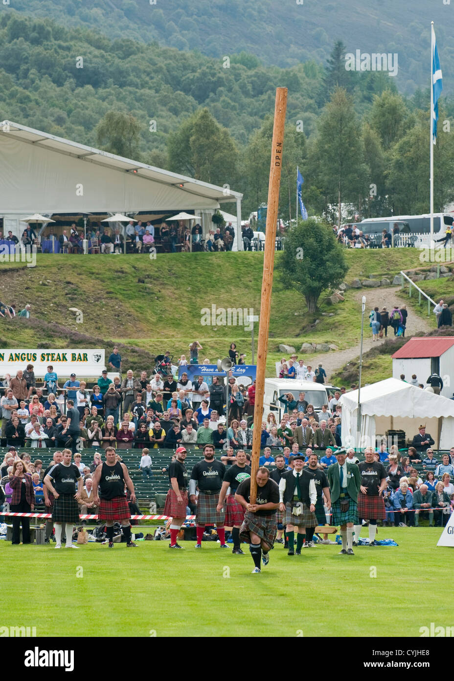 Man competing in a "Toss the Caber" competition at the Royal Highland ...