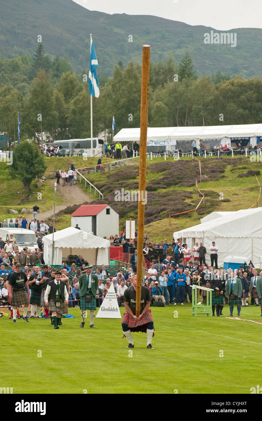 Man competing in a "Toss the Caber" competition at the Royal Highland
