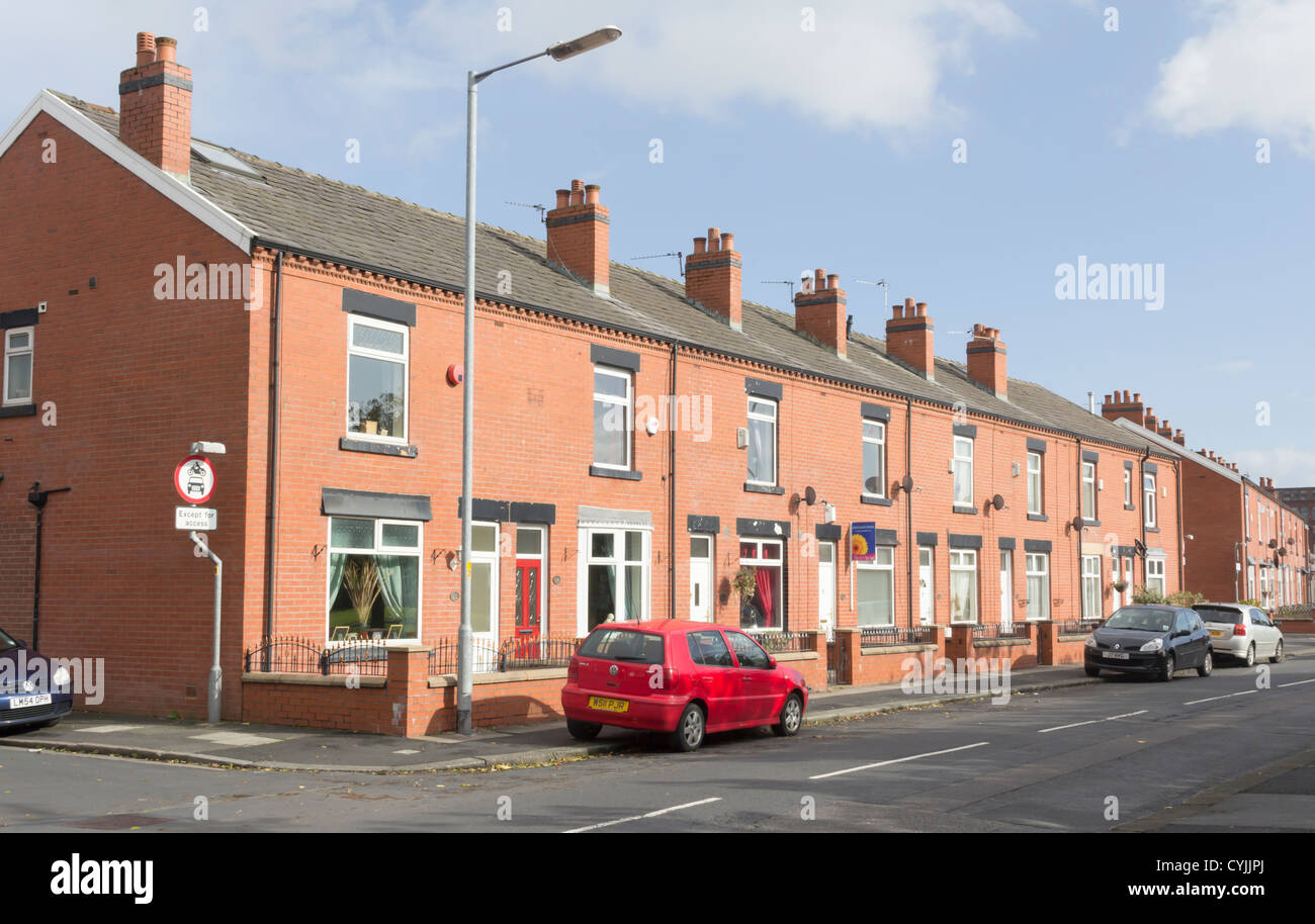 Nineteenth century terraced houses, modernised,  with small front garden (often paved over) on Campbell Street, Farnworth. Stock Photo