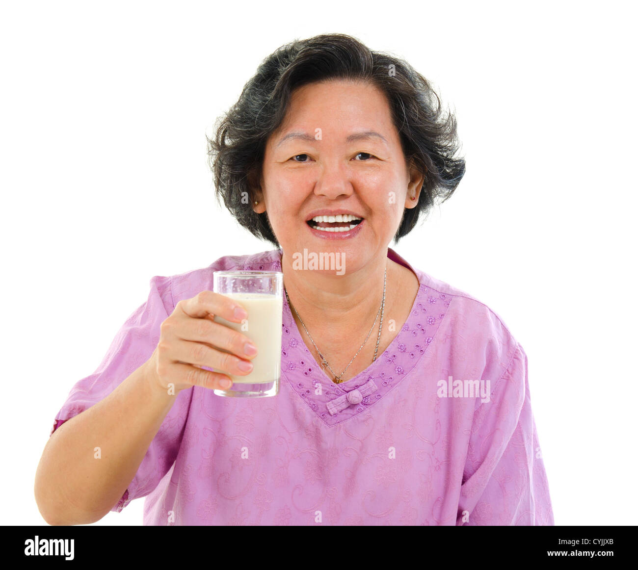 Asian senior woman drinking a glass of soy milk over white background