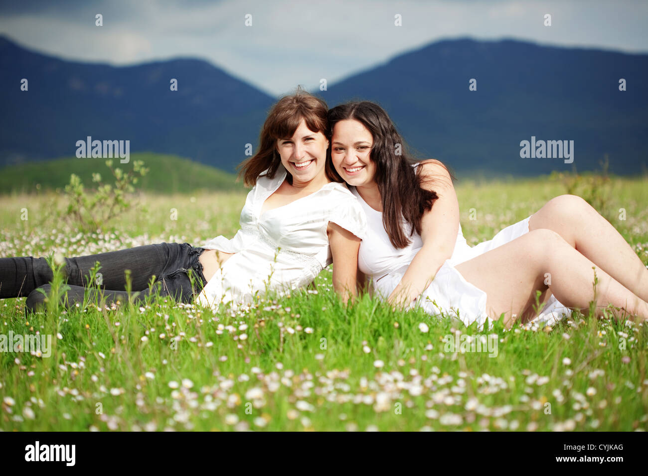 Two happy smiling girls outdoors Stock Photo - Alamy
