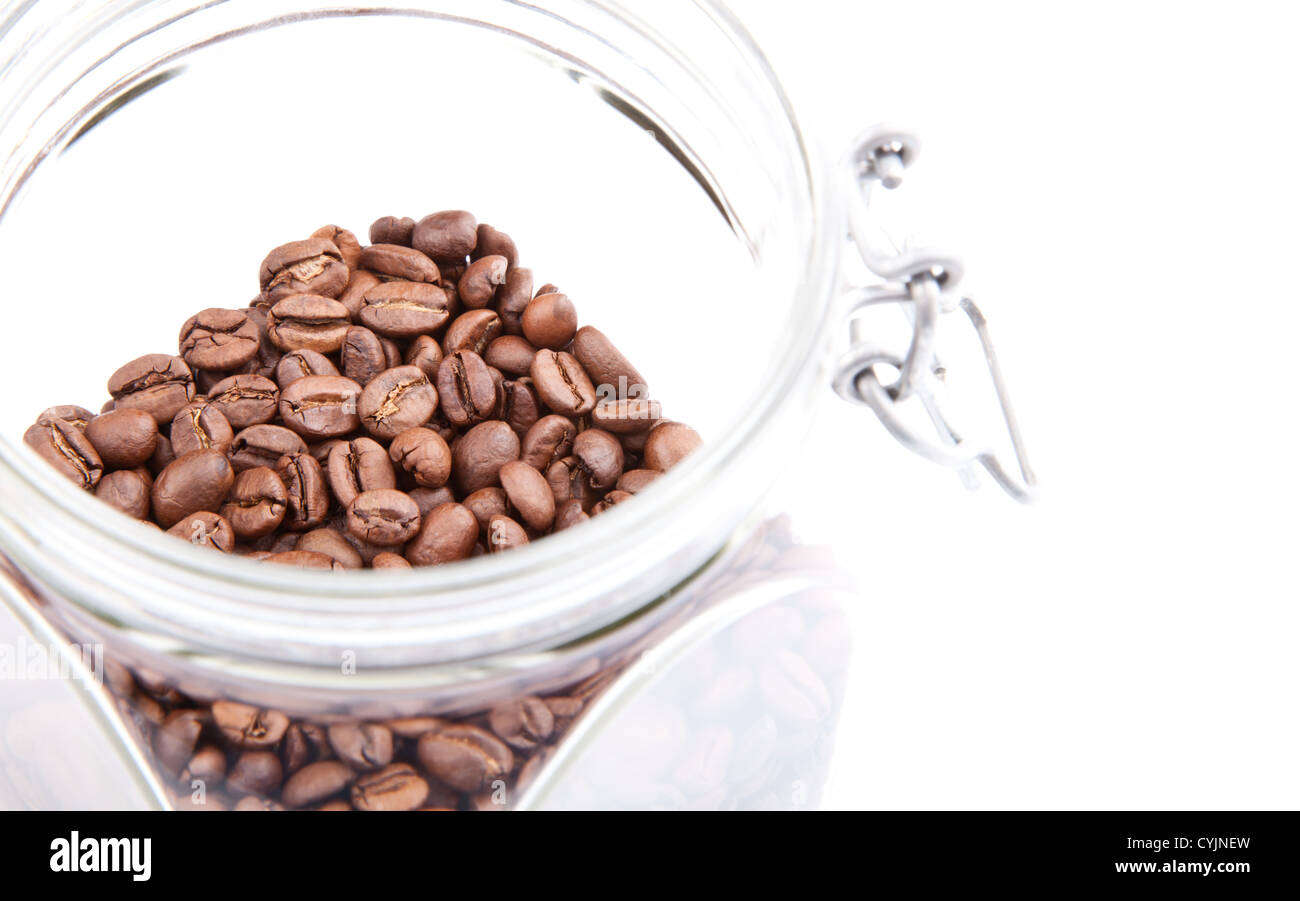 Fragrant coffee beans in a glass jar isolated on white background. Shallow depth of field Stock Photo