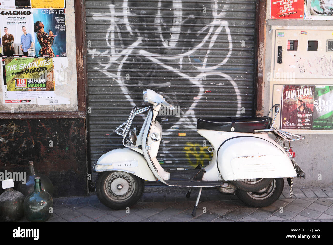 Classic Vespa scooter white parked on roadside, Central Madrid, Spain Stock Photo