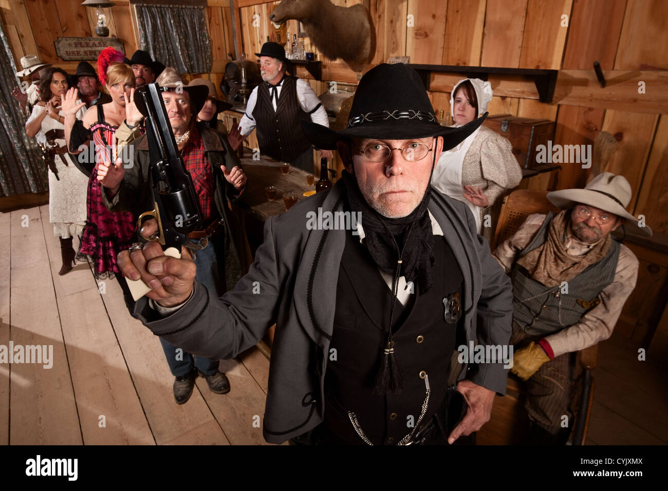 Serious old west sheriff in bar with scared customers Stock Photo