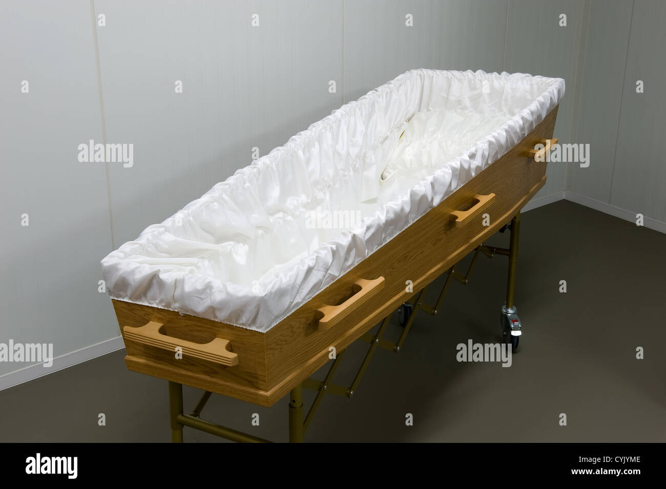 An empty coffin with white sheet in a Stock Photo Alamy