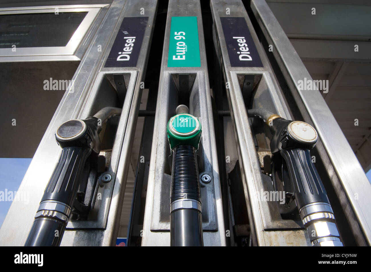 Three fuel nozzles at a gas station Stock Photo Alamy