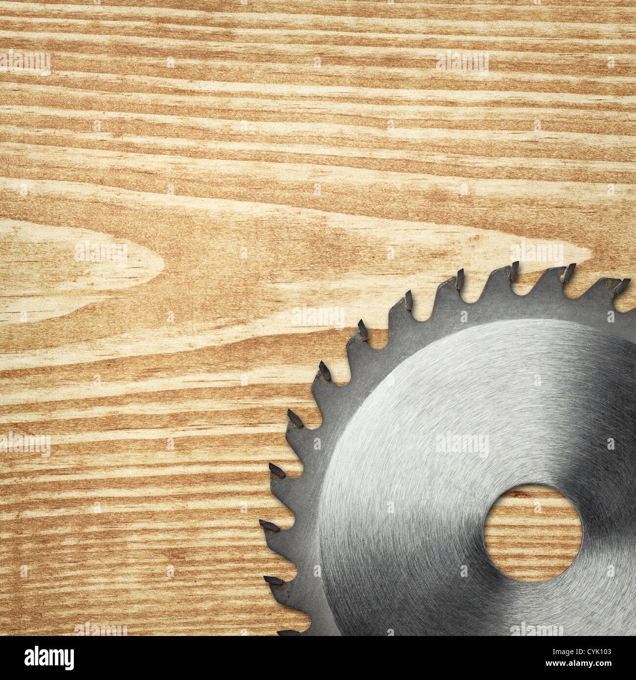 Circular saw blade on a wood board. Stock Photo