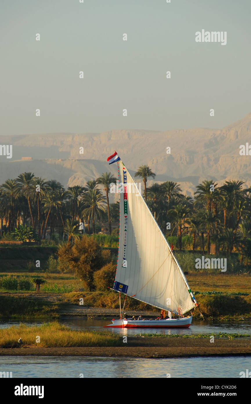 LUXOR, EGYPT. A felucca sailing along the fertile west bank of the River Nile. 2009. Stock Photo