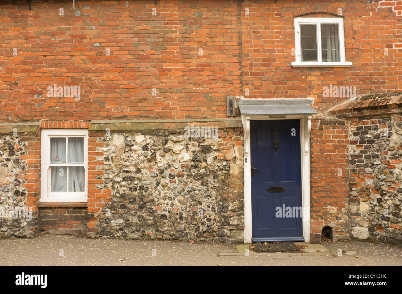 Single blue door in a flint work house in Cathedral Close in Norwich, Norfolk, UK Stock Photo