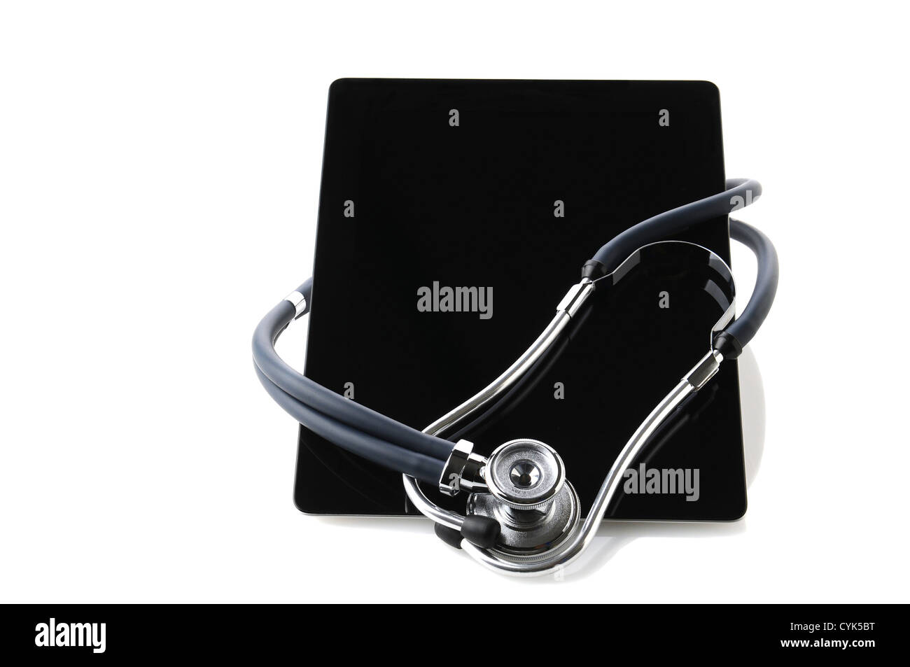 A tablet computer with a Stethoscope wrapped around. Horizontal format with reflections on a white background. Stock Photo