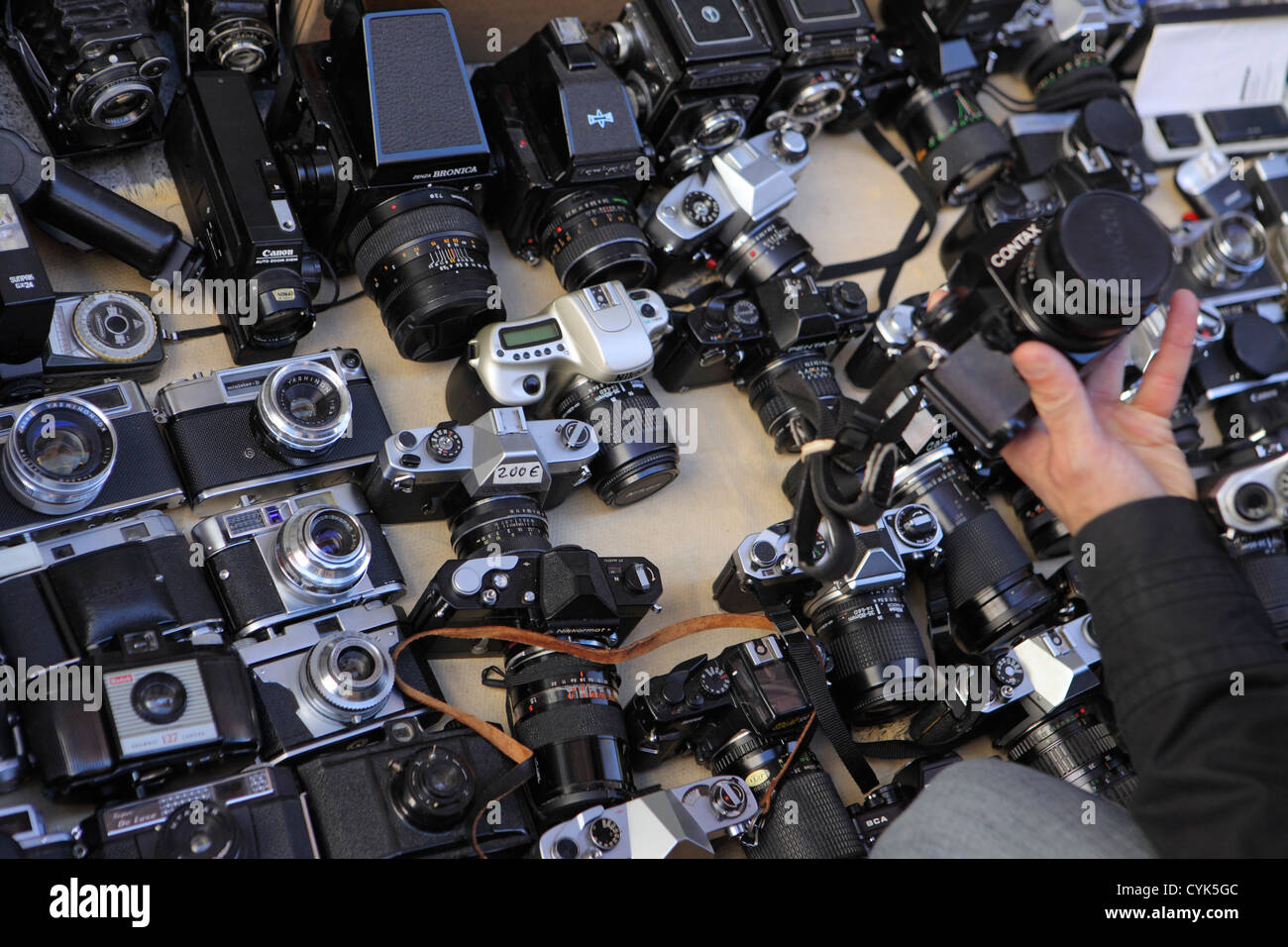 Shopper examines chooses, second hand pre-owned analogue film Camera El  rastro street market, Madrid, Spain Stock Photo - Alamy