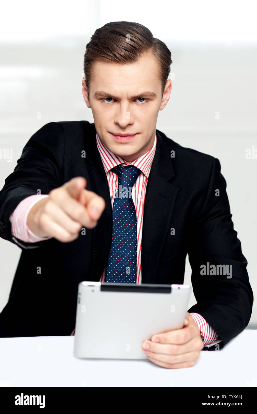 Tech savvy corporate man pointing at you. Serious look on face Stock Photo