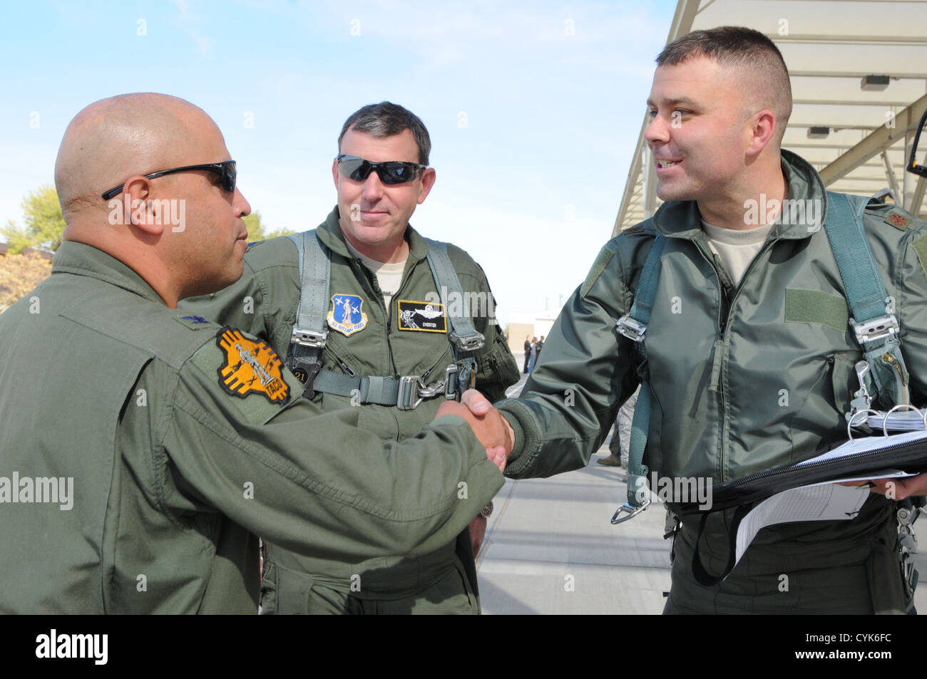 Col. Joe Martinez II (left), Wing Commander of the Albuquerque 150th Fighter Wing, greats Lt. Col. Ronald Hedges (middle) and Maj. Jim Hawkes, pilots from the Idaho Air National Guard, and welcome the 124th Fighter Wing members and 190th Fighter Squadron Stock Photo