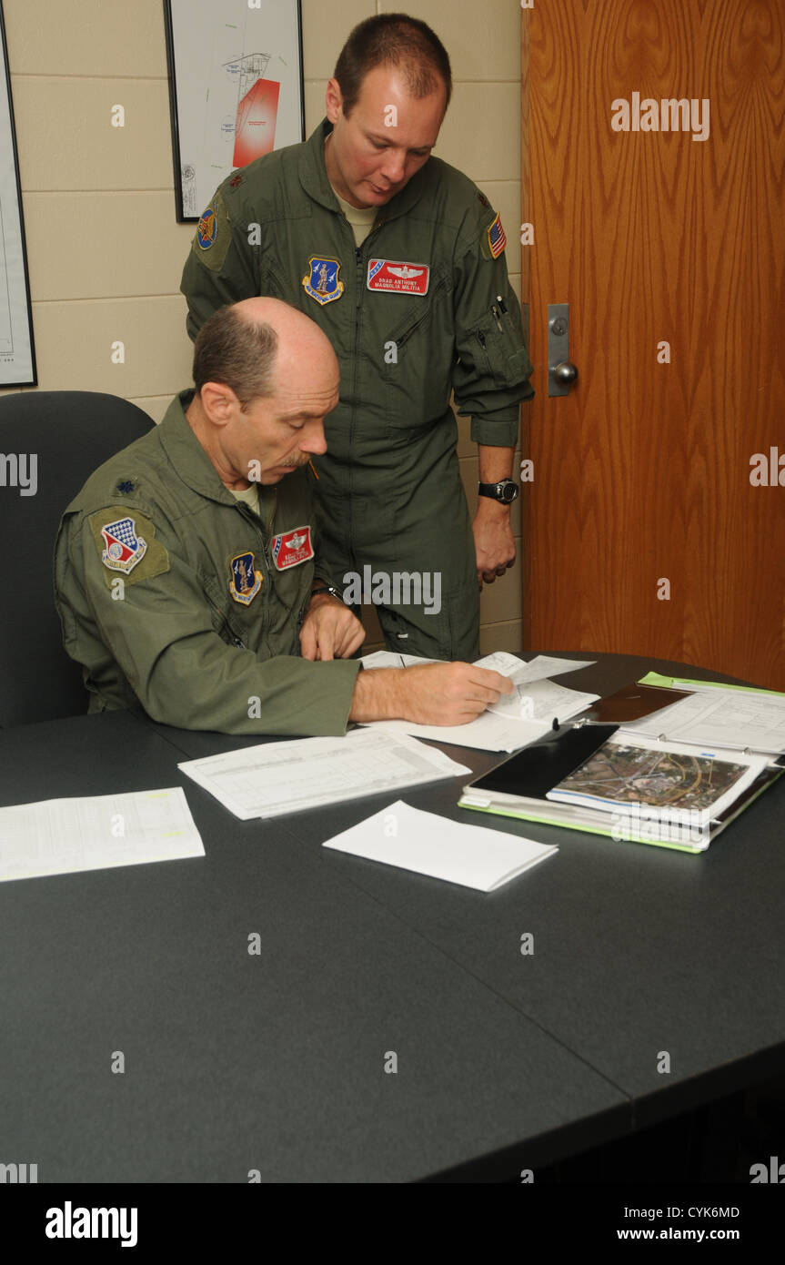 U. S. Air Force Col. Kelly Miller, aircraft pilot, and Maj. Brad Anthony, aircraft copilot, discuss flight plans on Key Field Air National Guard Base, Meridian, Miss. Nov. 3, 2012. Miller and Anthony prepare to fly a U. S. Air Force C-27J Spartan military Stock Photo