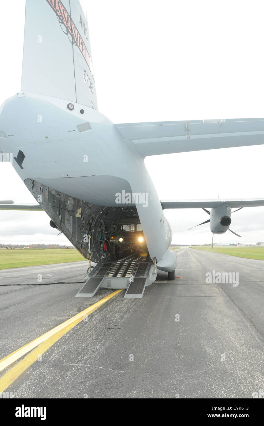 A U. S. Army Humvee from the Ohio National Guard is loaded on board a U. S. Air Force C-27J Spartan military transport aircraft Stock Photo