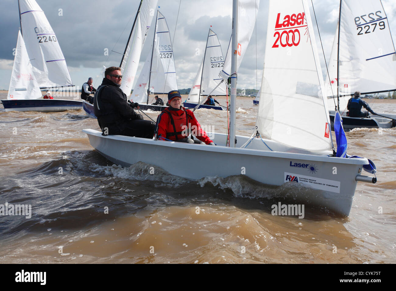 Couple sailing in Laser 2000 class meet at Snettisham in Norfolk. Stock Photo