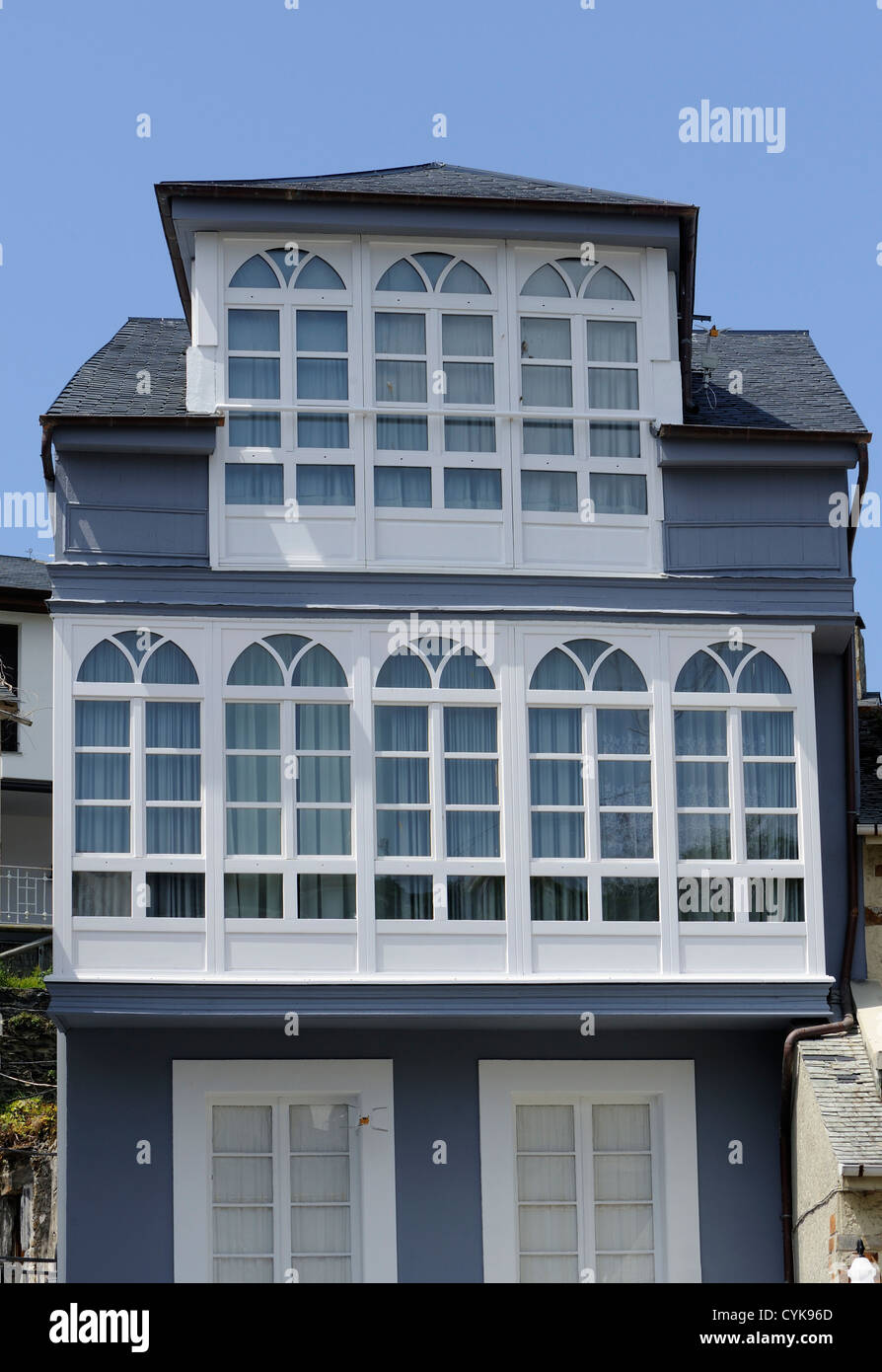 A harbour side house with traditional glazed window balconies, galerías. Luarca, Asturias, Spain. Stock Photo