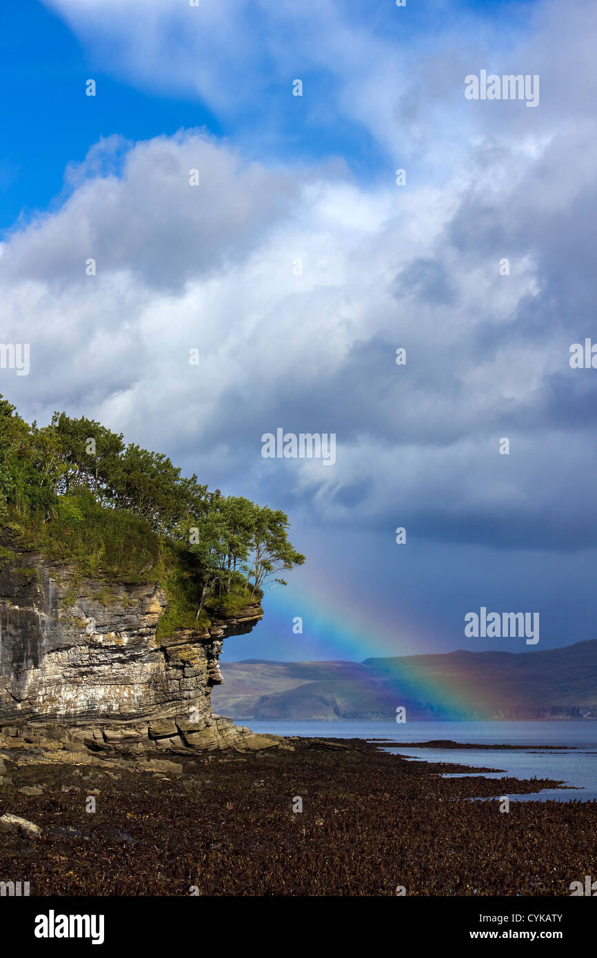 Rainbow over Scottish rock headland cliffs, Isle of Skye, Scotland Stock Photo