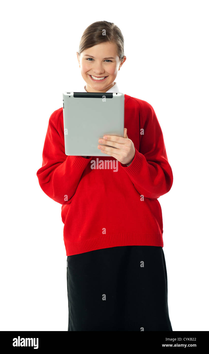 Confident smiling girl using wireless portable device on white background Stock Photo