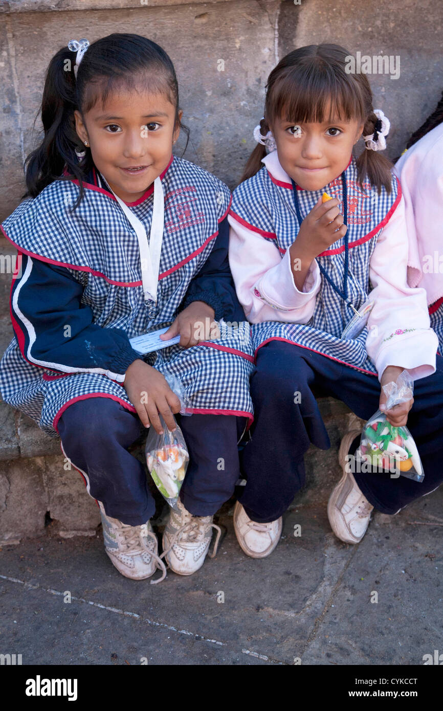 North America, Mexico, Guanajuato, two girls in school uniforms with Day of the Dead candy. UNESCO World Heritage Site. Stock Photo