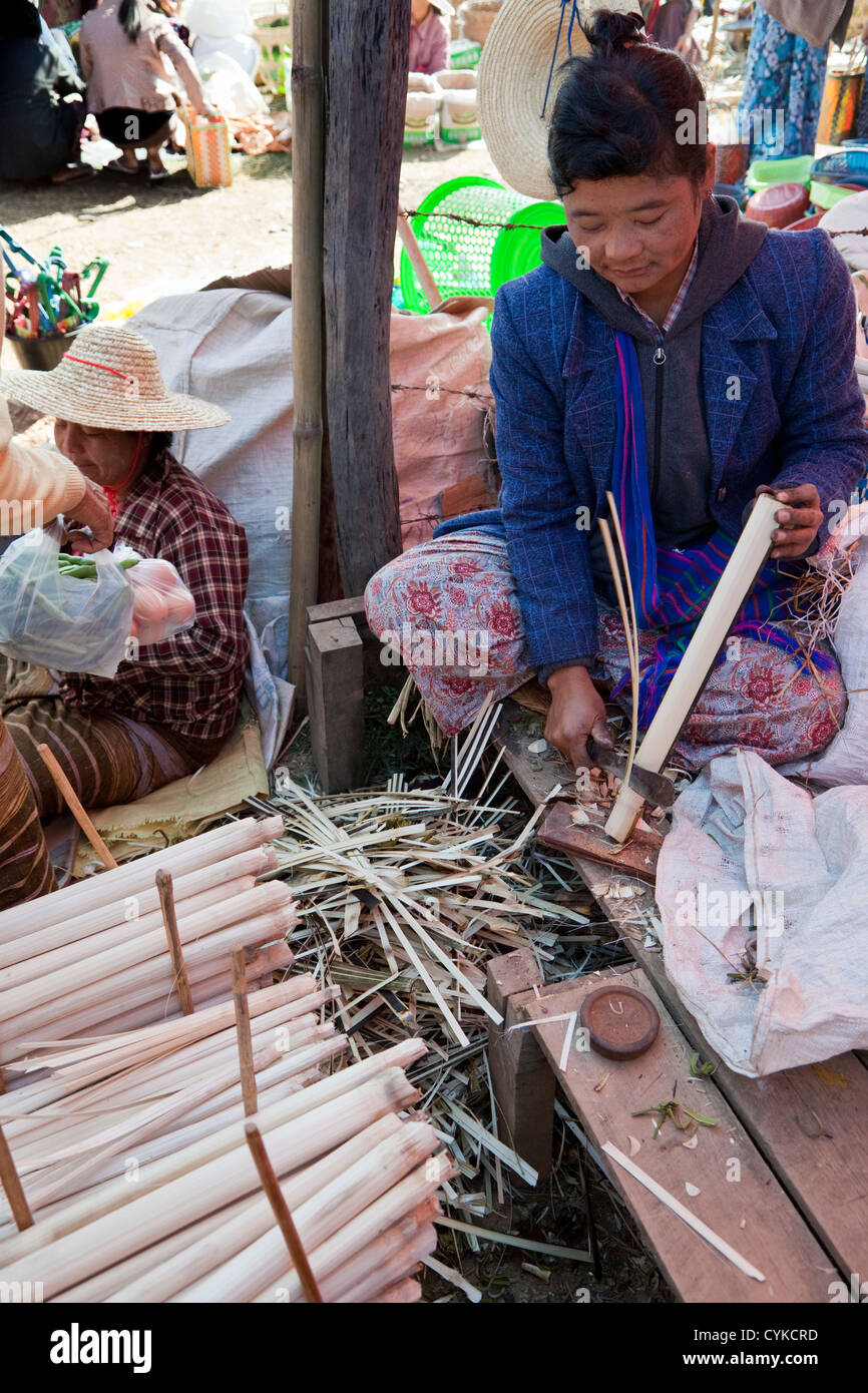 Myanmar, Burma. Woman Slicing Bamboo to Make Strips to Make Bamboo