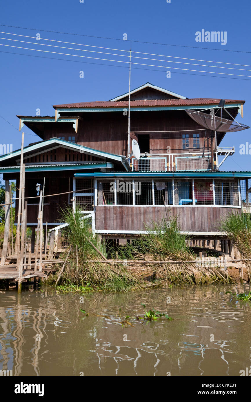 Myanmar, Burma. Village House on Stilts, with Satellite Dish, Inle Lake, Shan State. Stock Photo