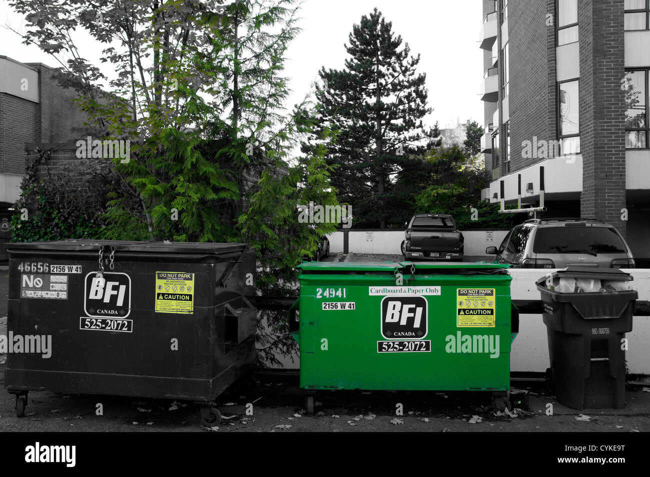 Selective colour green reycycling dumpster in Vancouver, British Columbia, Canada Stock Photo