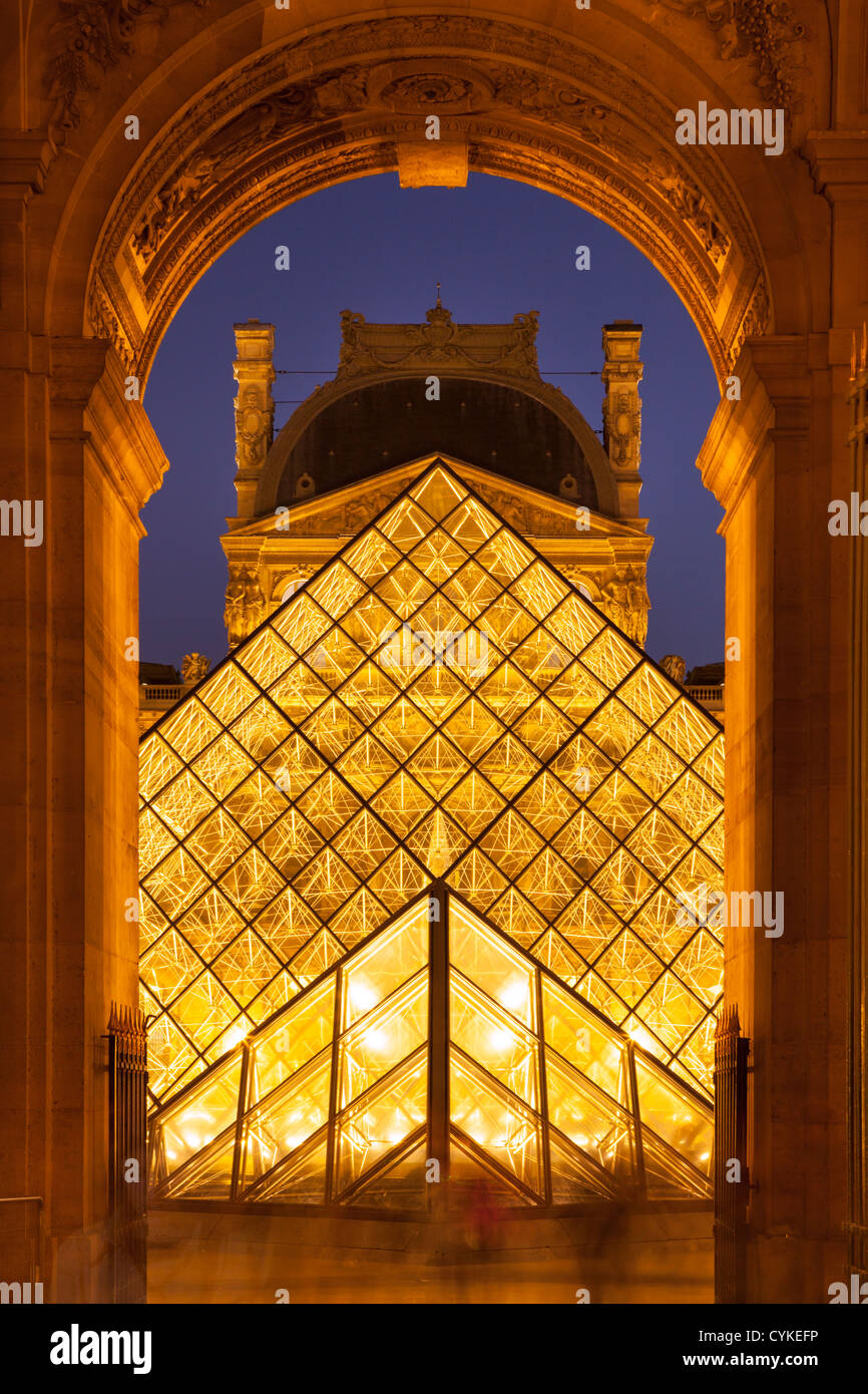 Evening at the glass pyramid at Musee du Louvre, Paris France Stock Photo