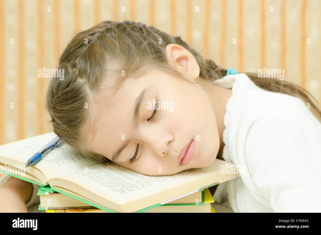 a tired student girl sleeping on books Stock Photo - Alamy