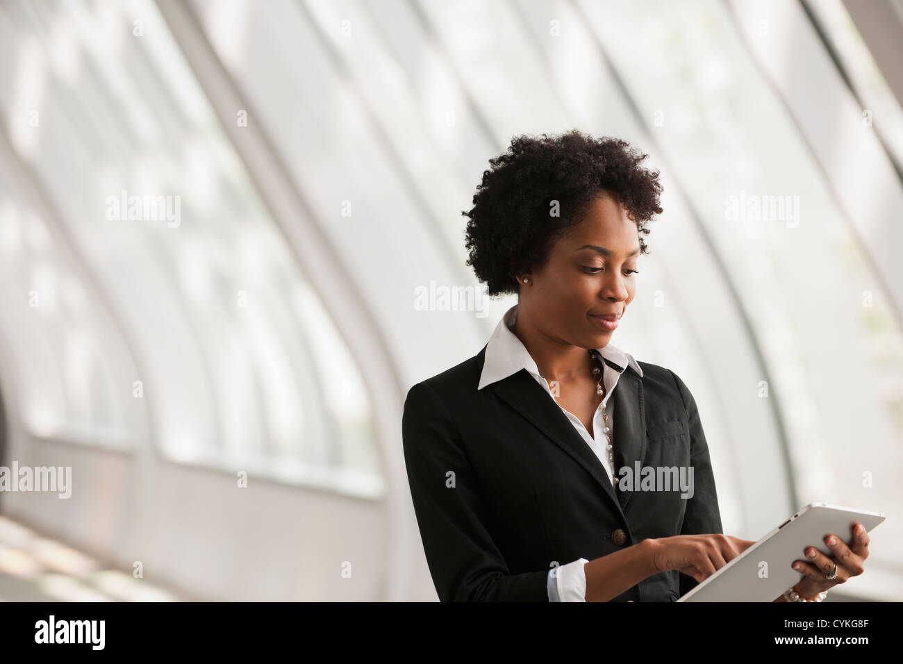 African American businesswoman using digital tablet Stock Photo - Alamy
