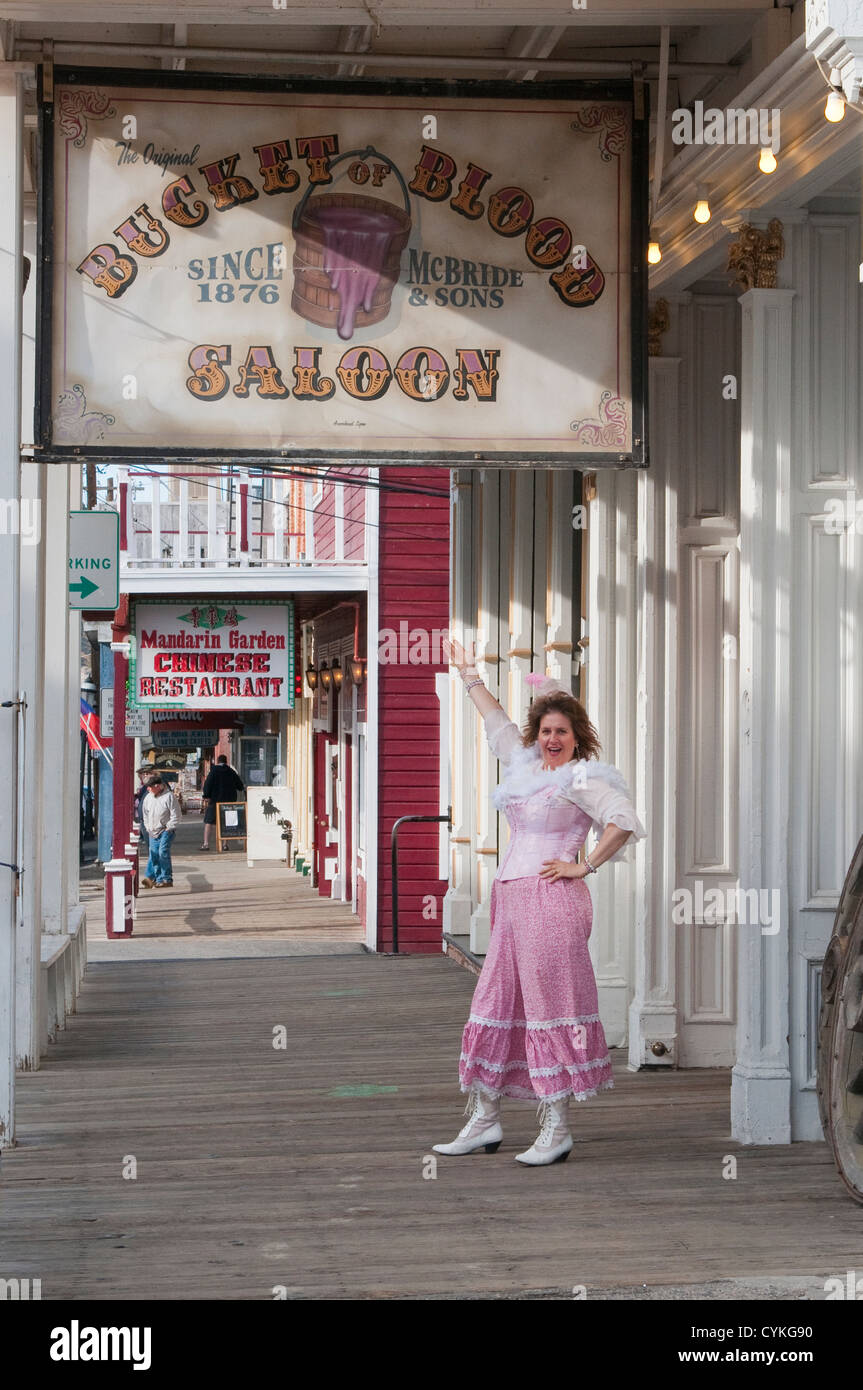 USA, Nevada. Woman and Bucket of Blood Saloon sign 1876 Virginia CIty, Nevada. Stock Photo