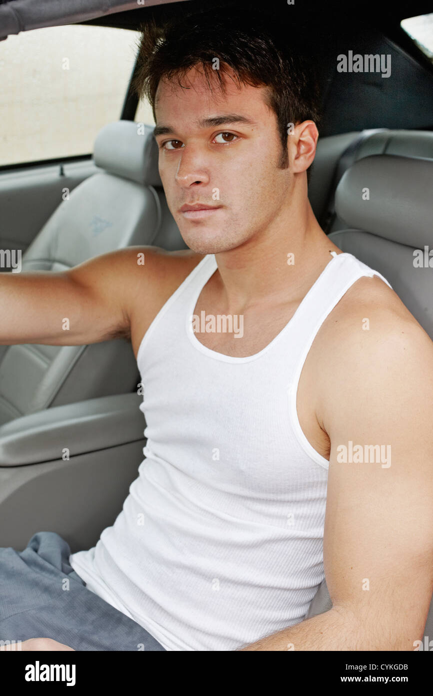 Young man sitting in sports car Stock Photo Alamy