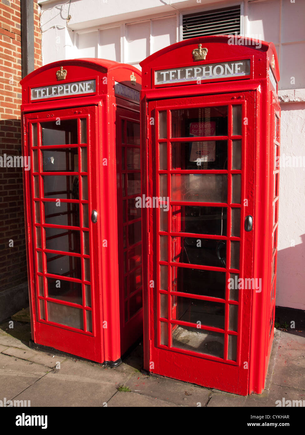 Twin red K6 kiosk telephone boxes designed by Sir Giles Gilbert Scott, North Street, Guildford City Centre Stock Photo